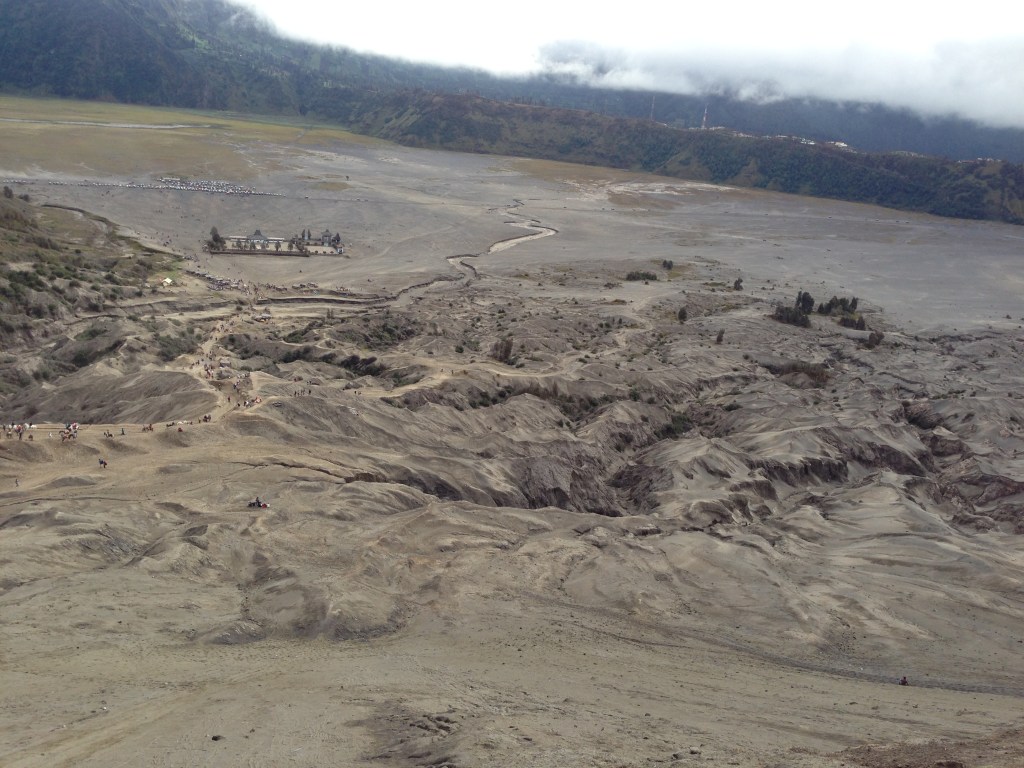 View of the sea of sand with hindu temple from the bromo crater