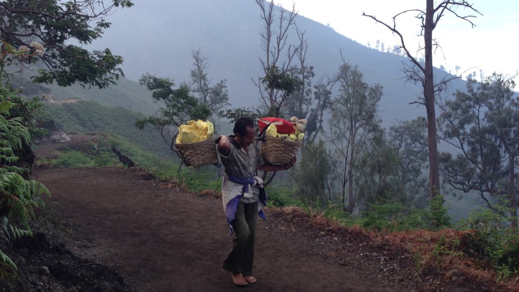 Sulphur mine worker at mount ijen, indonesia